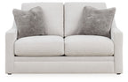 Chalk loveseat front view with two dark gray pillows on a padded back