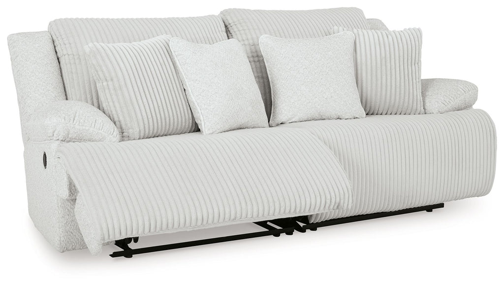 Light gray reclining sectional sofa with striped cushions and multiple throw pillows
