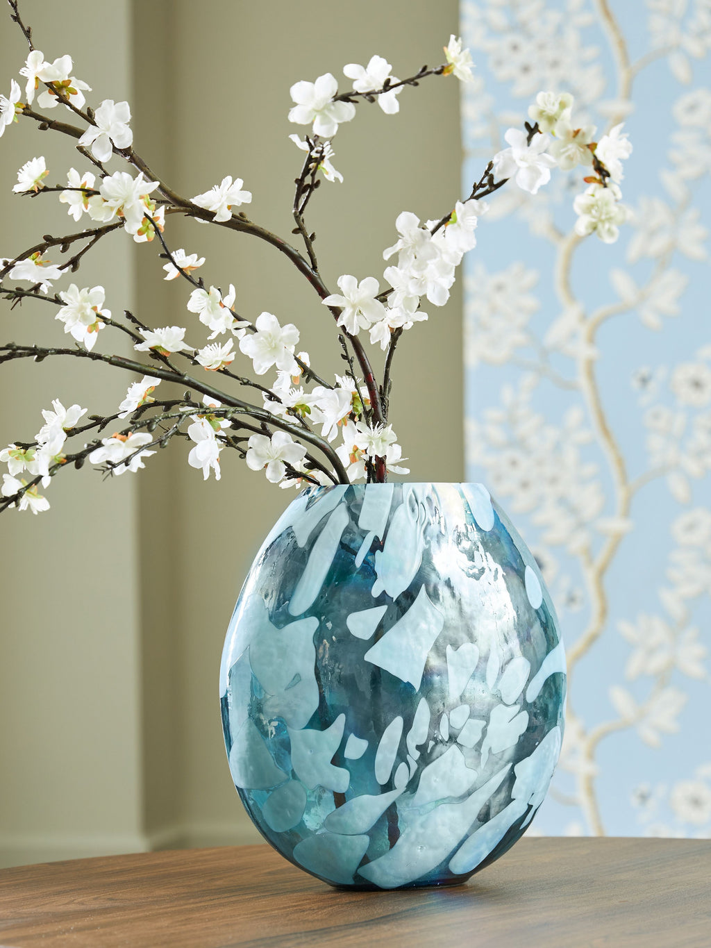 Blue glass vase with rounded form and flared opening, abstract mosaic-like pattern