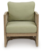 Outdoor lounge chair with green upholstered cushions and light beige wood frame