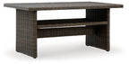 Brown rectangular multi-use table with woven frame and lower open shelf