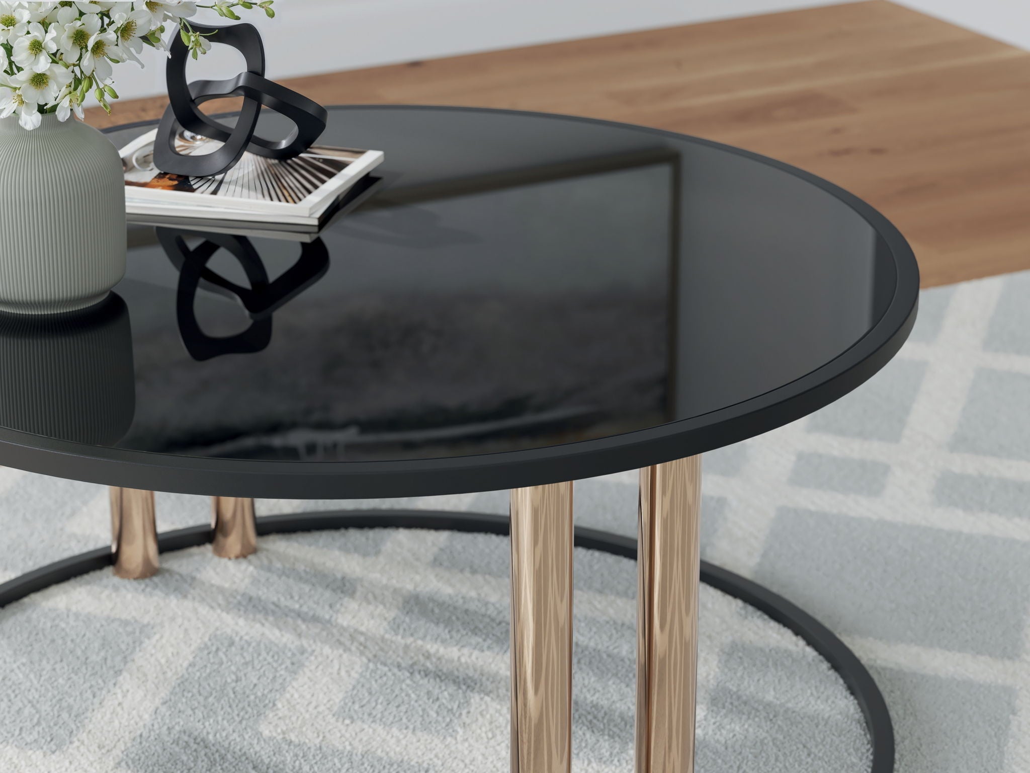 Round dark glass top occasional table with gold-finish legs, close-up