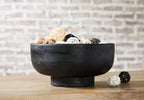 Bowl by Brynington, black round bowl on pedestal base holding decorative fillers