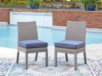 Set of 2 outdoor side chairs with blue cushions, gray woven backs, and tapered legs