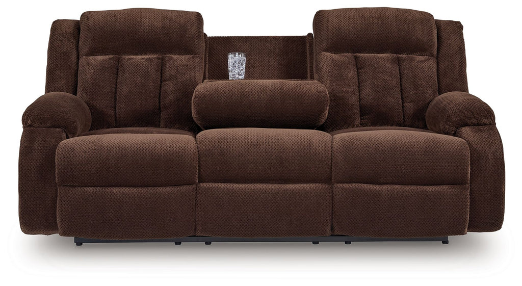 Chocolate brown reclining power sofa with two chaise seats and central headrest pillow