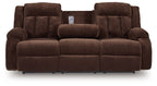 Chocolate brown reclining power sofa with two chaise seats and central headrest pillow