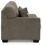 Dark gray-brown sofa arm end with tall backrest and patterned throw pillow, black feet.