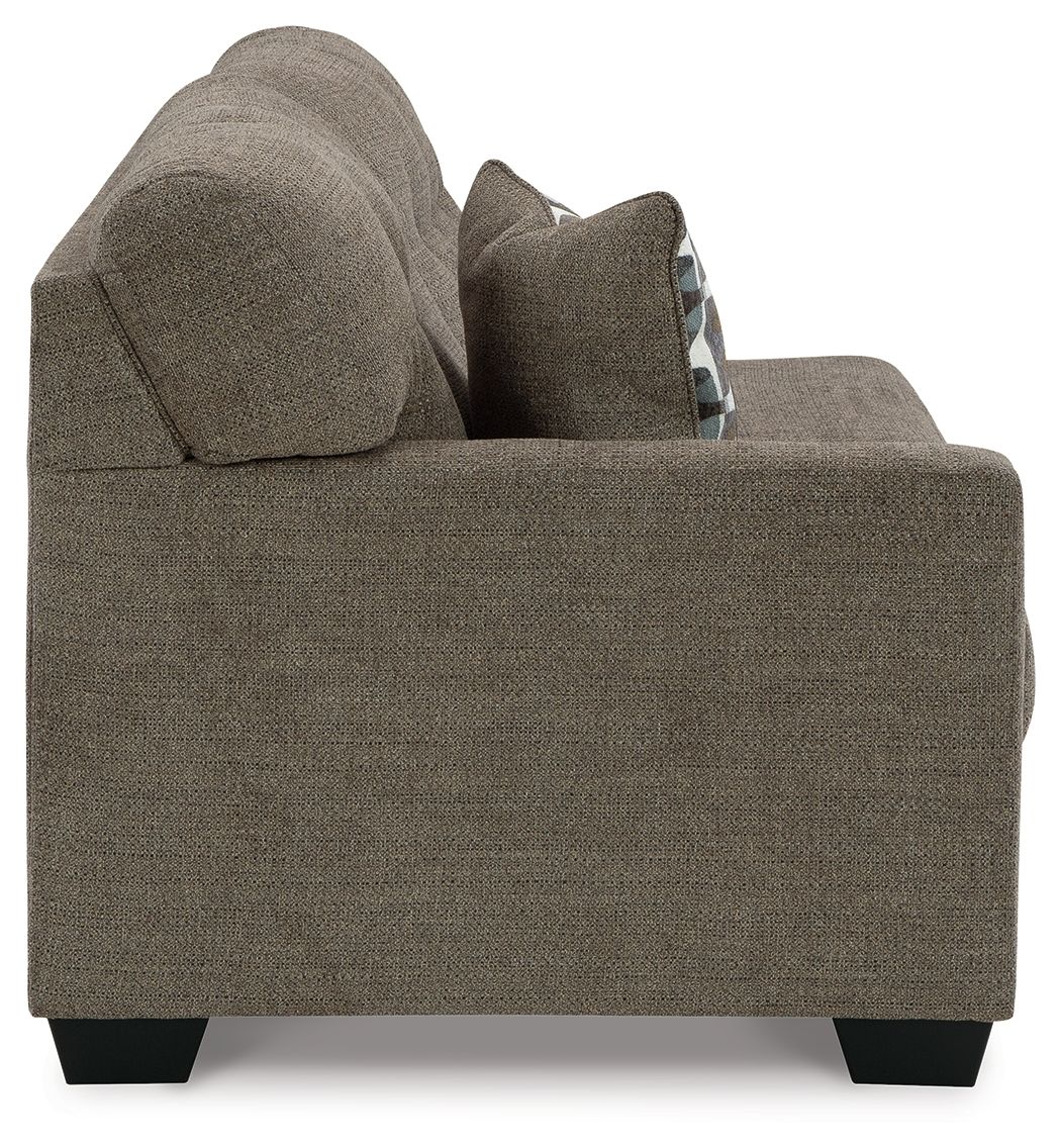 Dark gray-brown sofa arm end with tall backrest and patterned throw pillow, black feet.