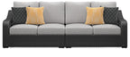 Outdoor loveseat front view with black wicker arms, light gray cushions, yellow and dark pillows