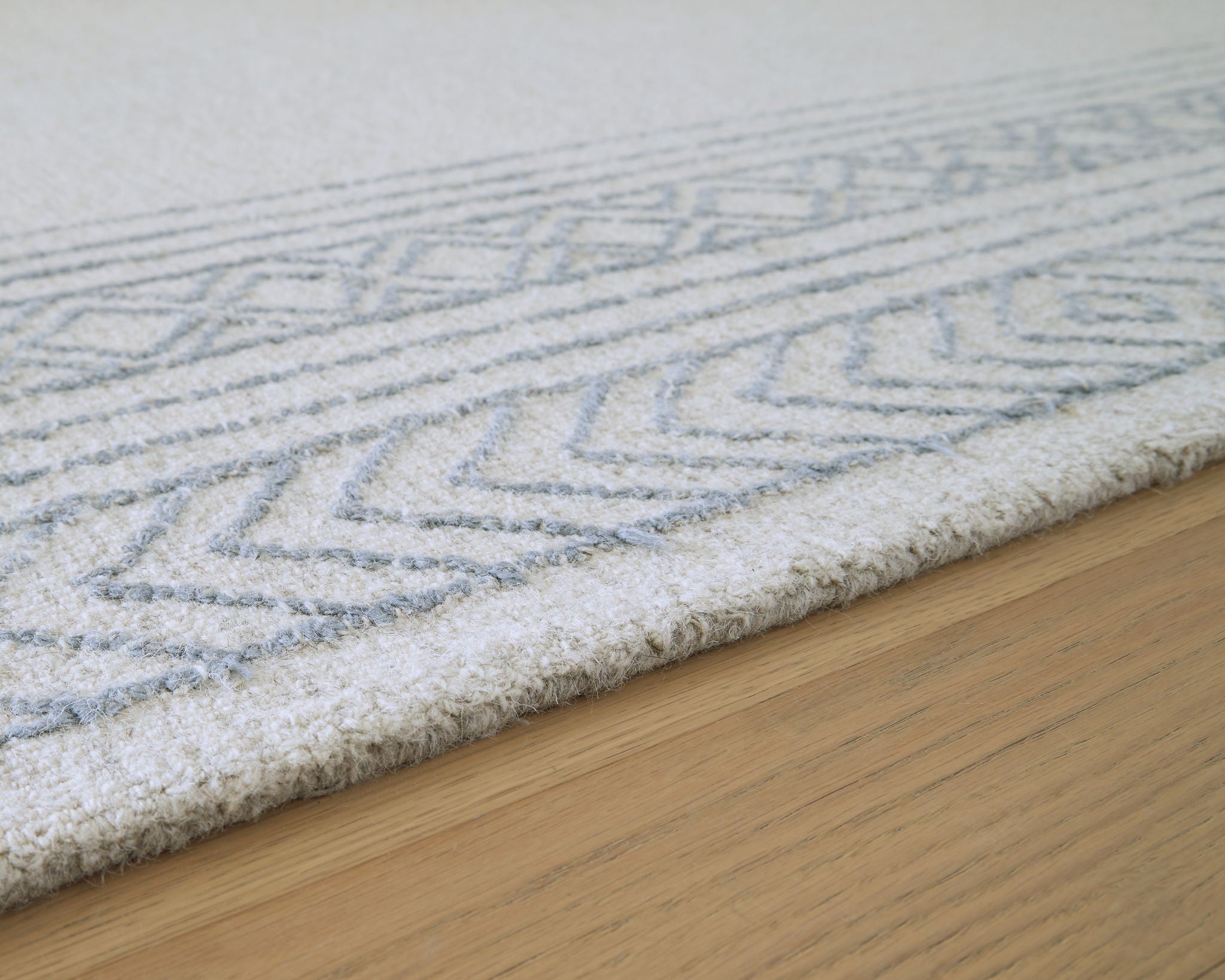 Blue and light gray geometric rug pattern close-up