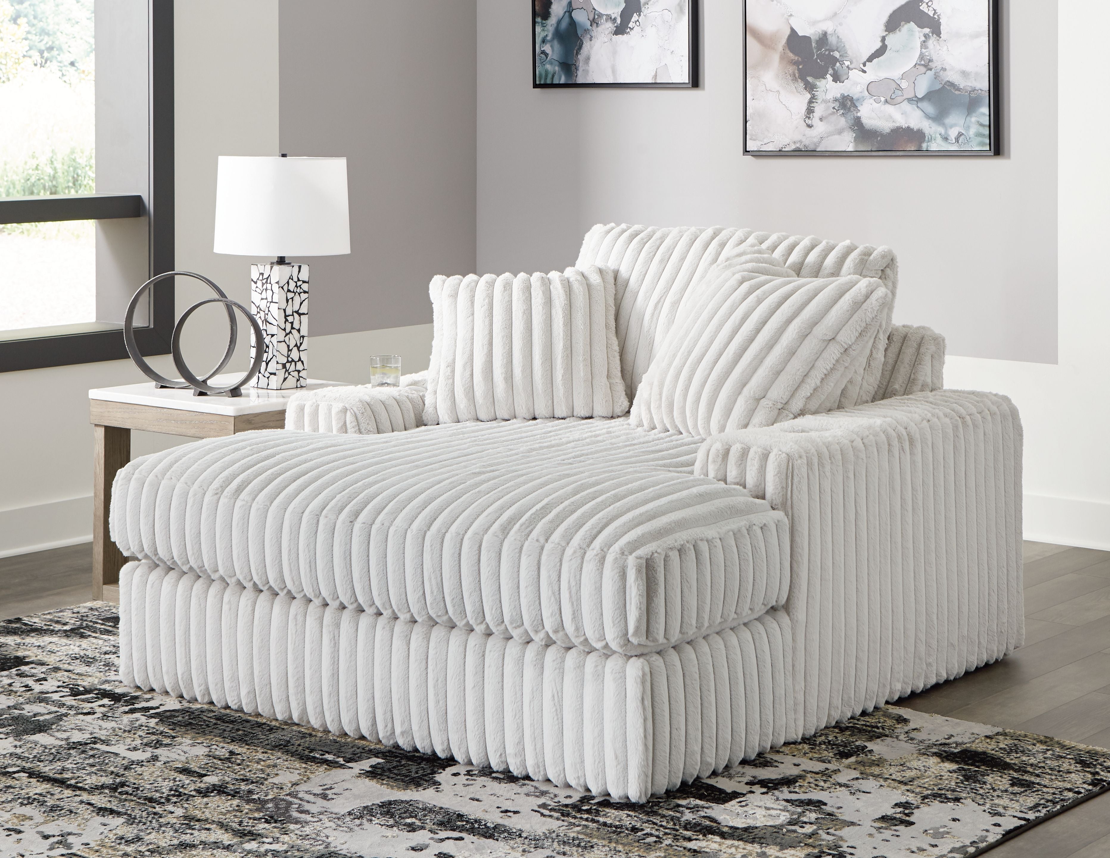 Oversized chaise lounge with ribbed upholstery and two back cushions, light gray