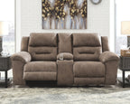 Power reclining sofa in dark brown plush fabric with three seat cushions