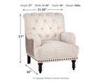 Light gray fabric accent chair with tufted back, padded arms, and turned dark wood legs.