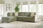 Moss green sectional sofa with corner chaise and patterned throw pillows