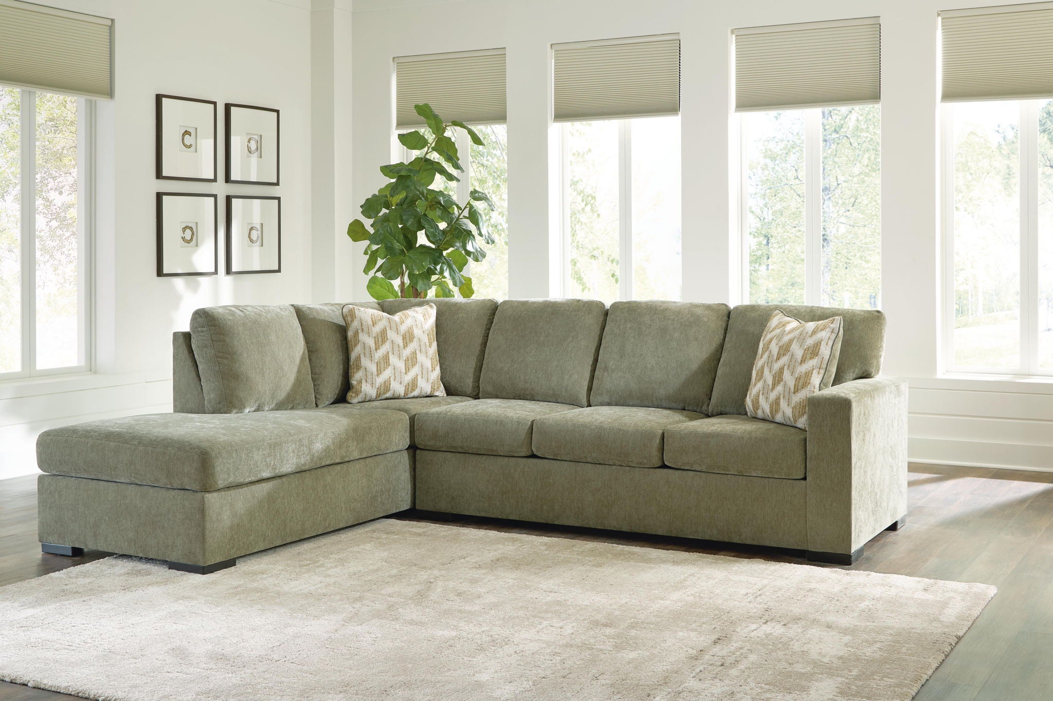 Moss green sectional sofa with corner chaise and patterned throw pillows