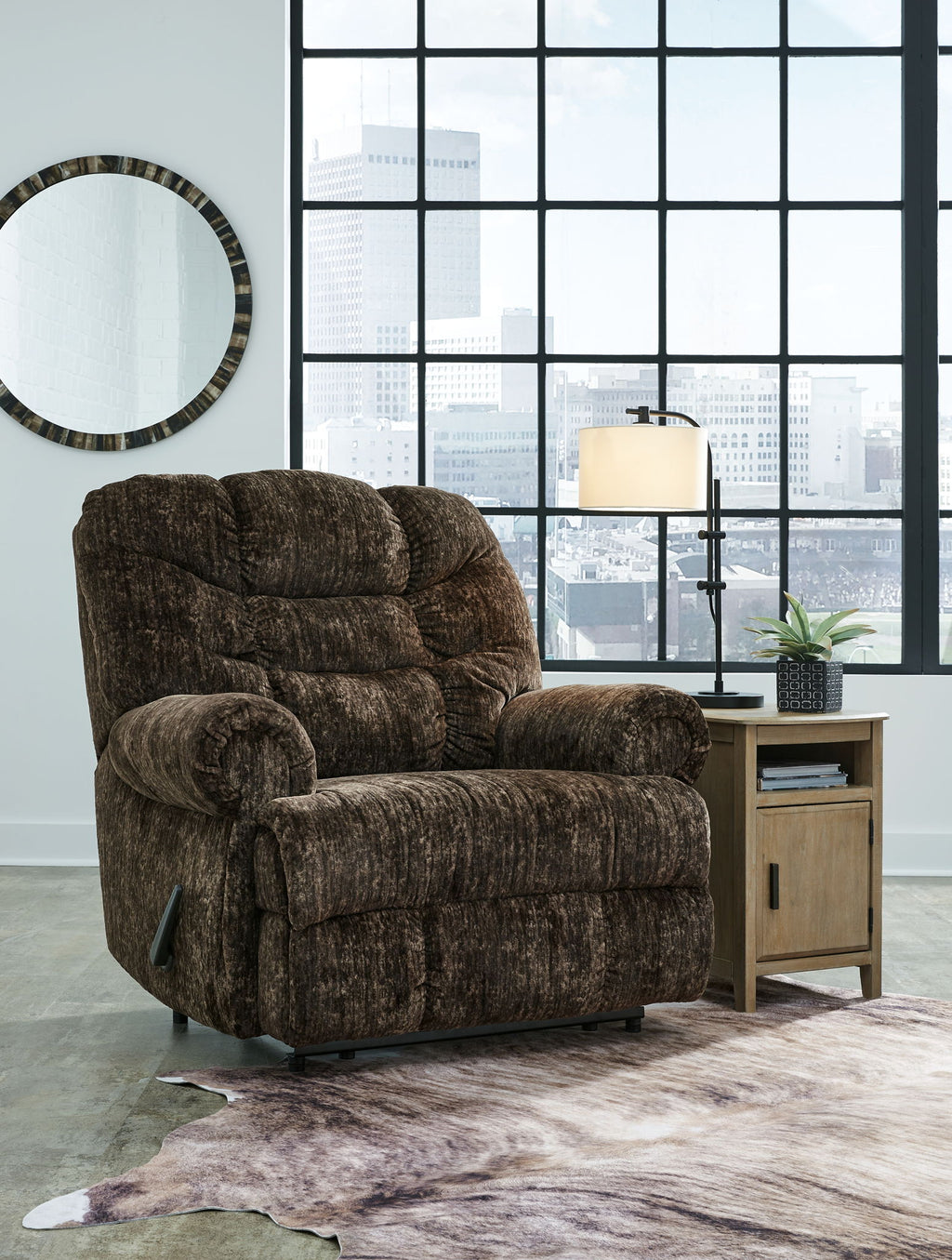 Chocolate brown fabric recliner with rolled arms, tufted back, and padded seat