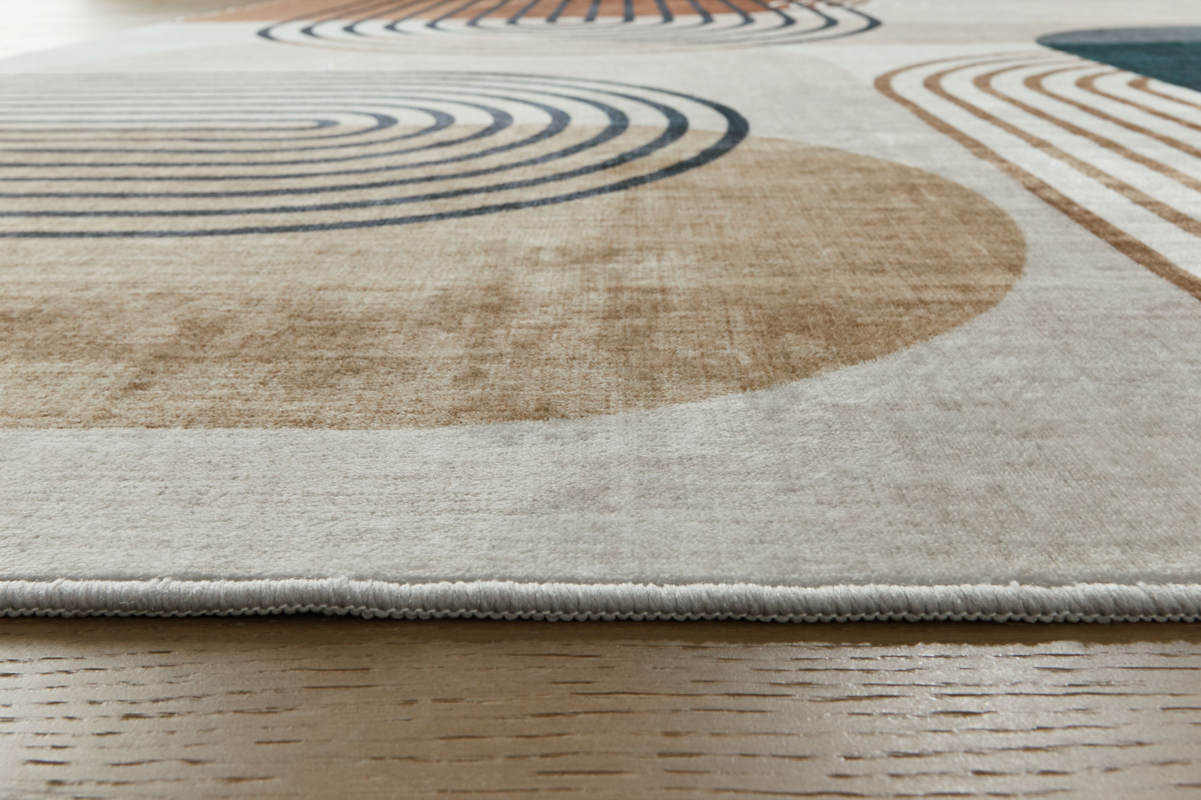 Farrendale washable rug border, beige ground with teal and tan curved stripe pattern