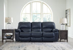 Leesworth ocean reclining sofa in blue with three padded headrests and wide armrests.