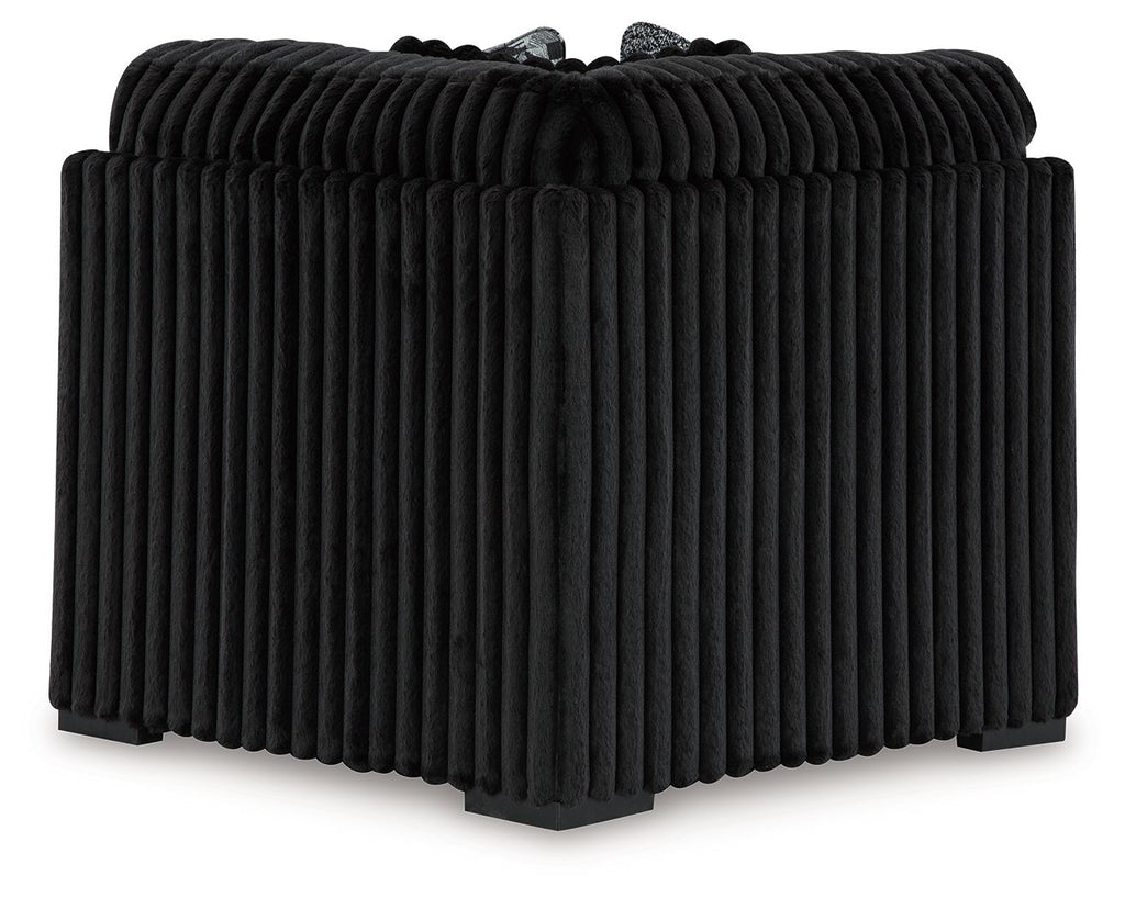Black ribbed wedge sofa section with rounded back and thick armrests