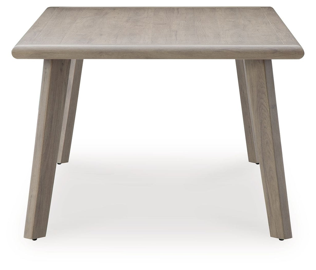 Beige rectangular dining table with square corners and four tapered legs