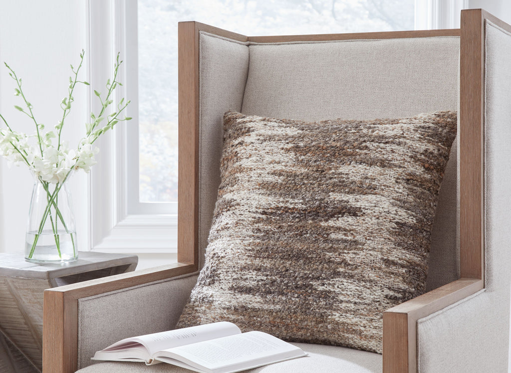 Decorative speckled cushion pillow in dark brown and beige on chair