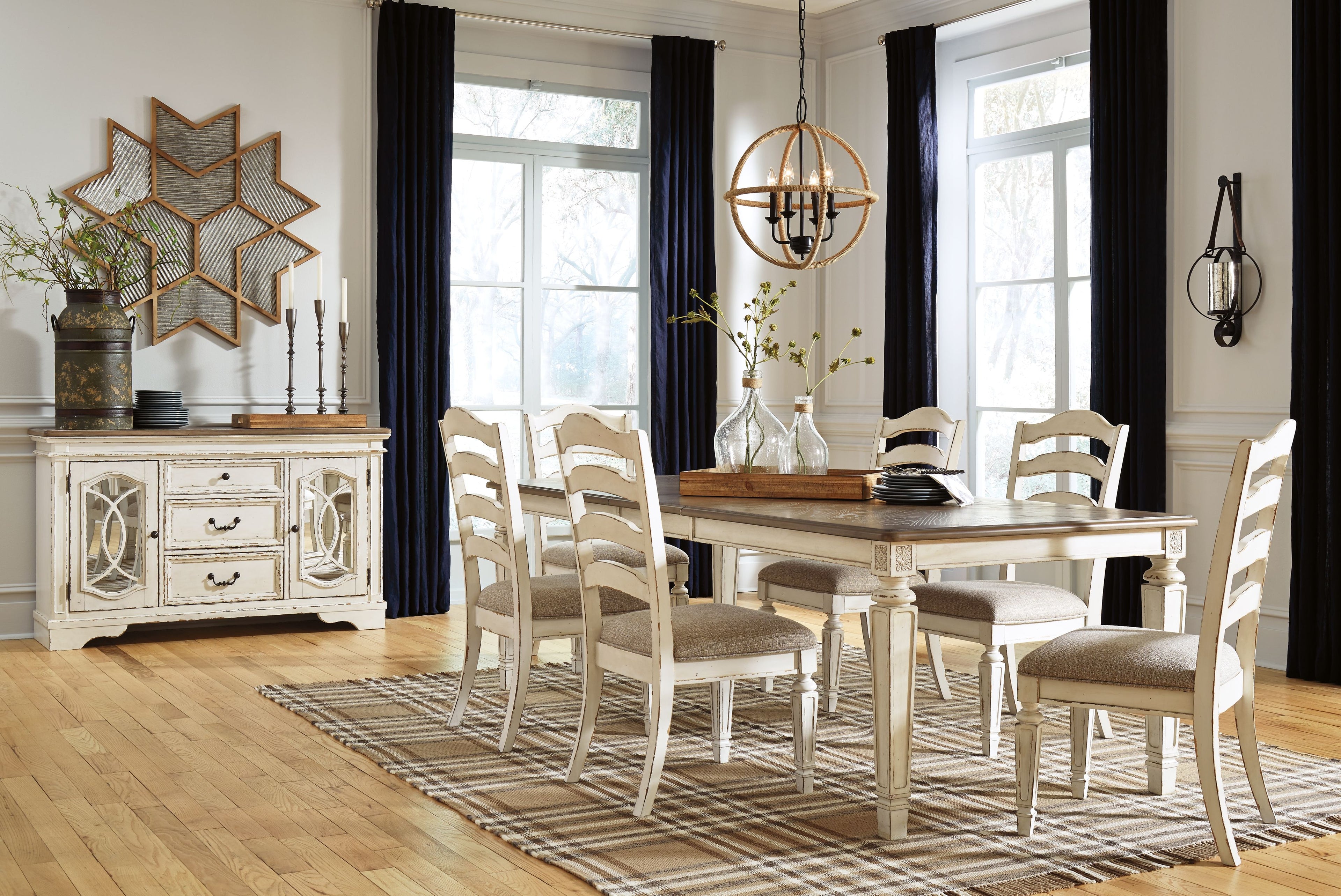 White rectangular dining table with matching chairs and server, staged for dining