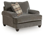 Gray chair-and-a-half with rounded arms, tufted back cushions, and plaid accent pillow
