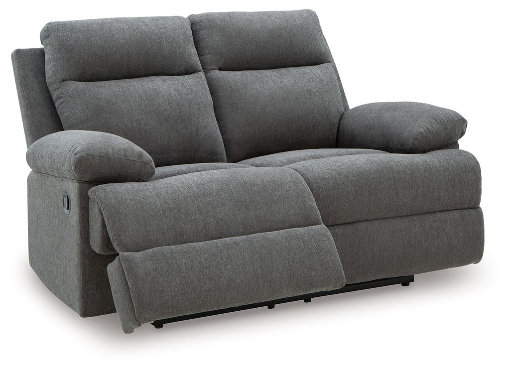 Dark gray reclining loveseat with wide arms, two back cushions, and leg rest