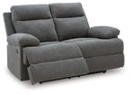 Dark gray reclining loveseat with wide arms, two back cushions, and leg rest