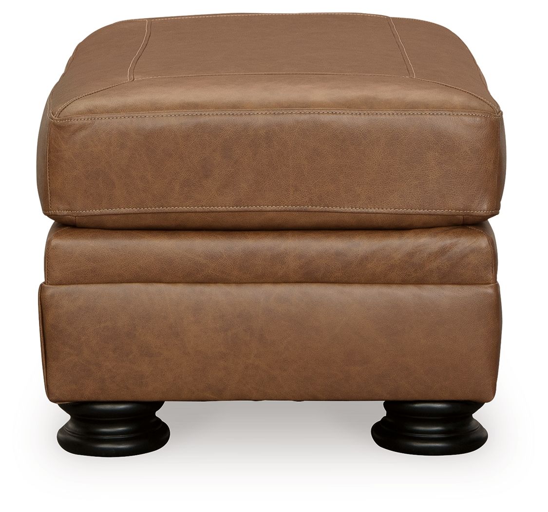 Carianna ottoman in caramel-brown upholstery with stitched panel detail and dark turned legs