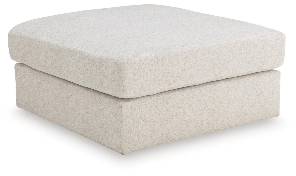 Beige upholstered ottoman with square top and low, boxy base