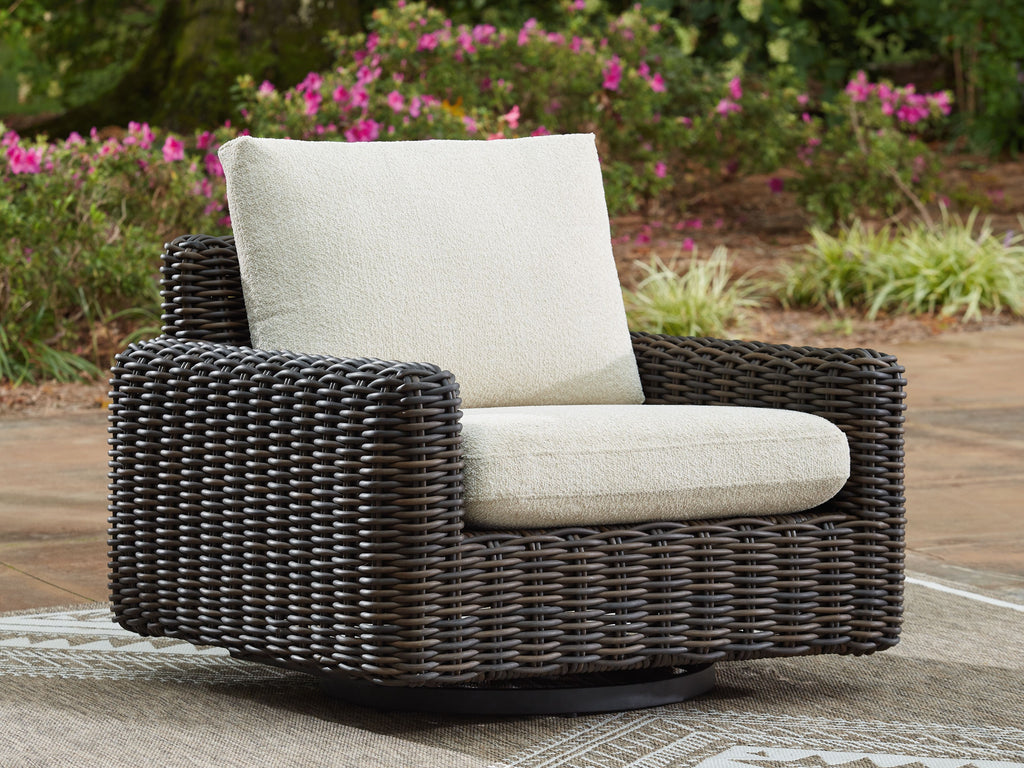 Dark brown wicker swivel glider lounge chair with beige seat and tall back cushion