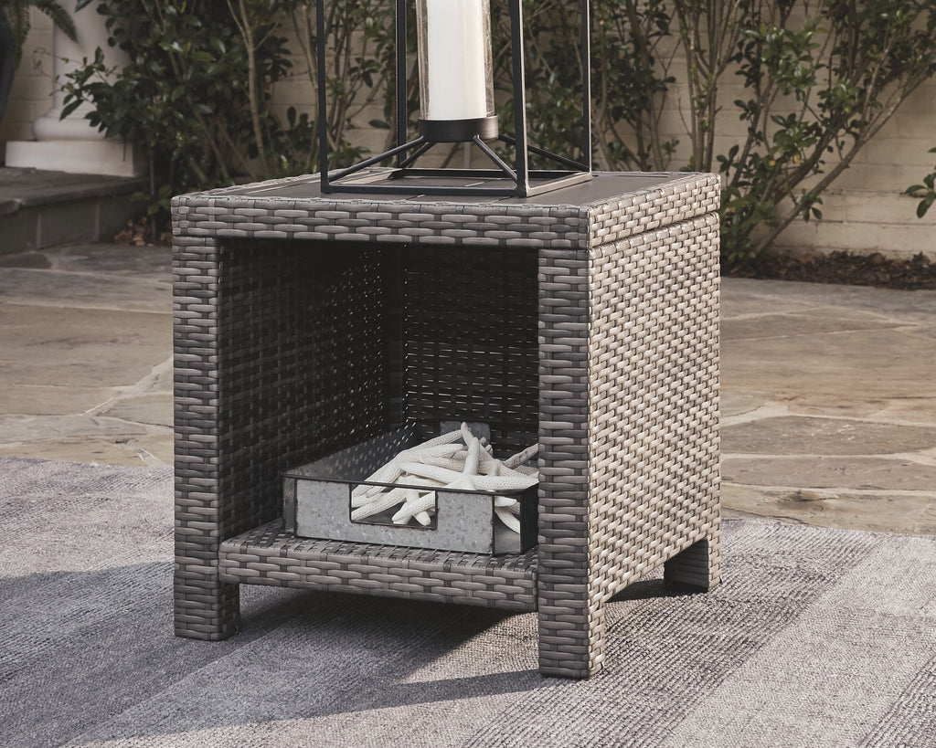 Gray square end table with woven rattan frame and dark open center
