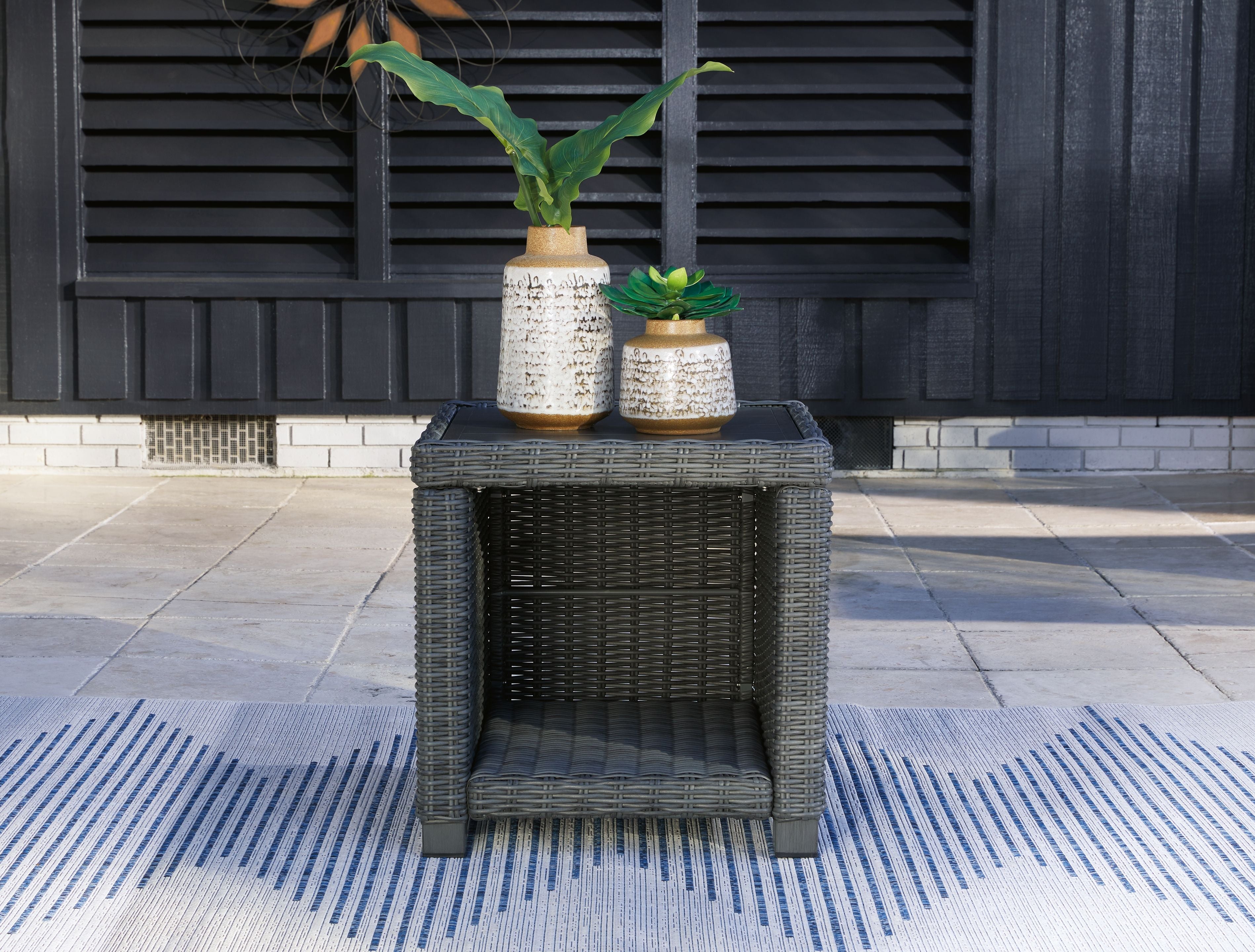 Gray wicker square end table with flat top and open lower shelf