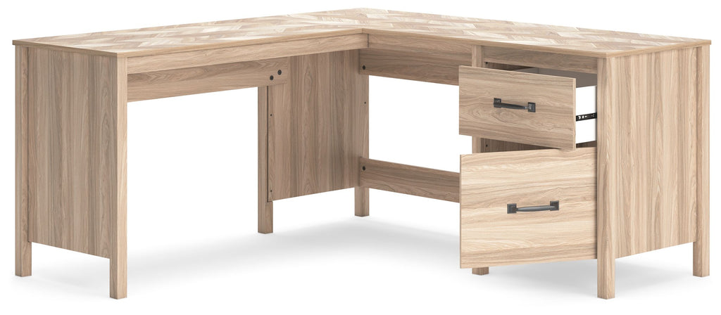 Tan home office desk with return and drawer pedestal, light woodgrain finish