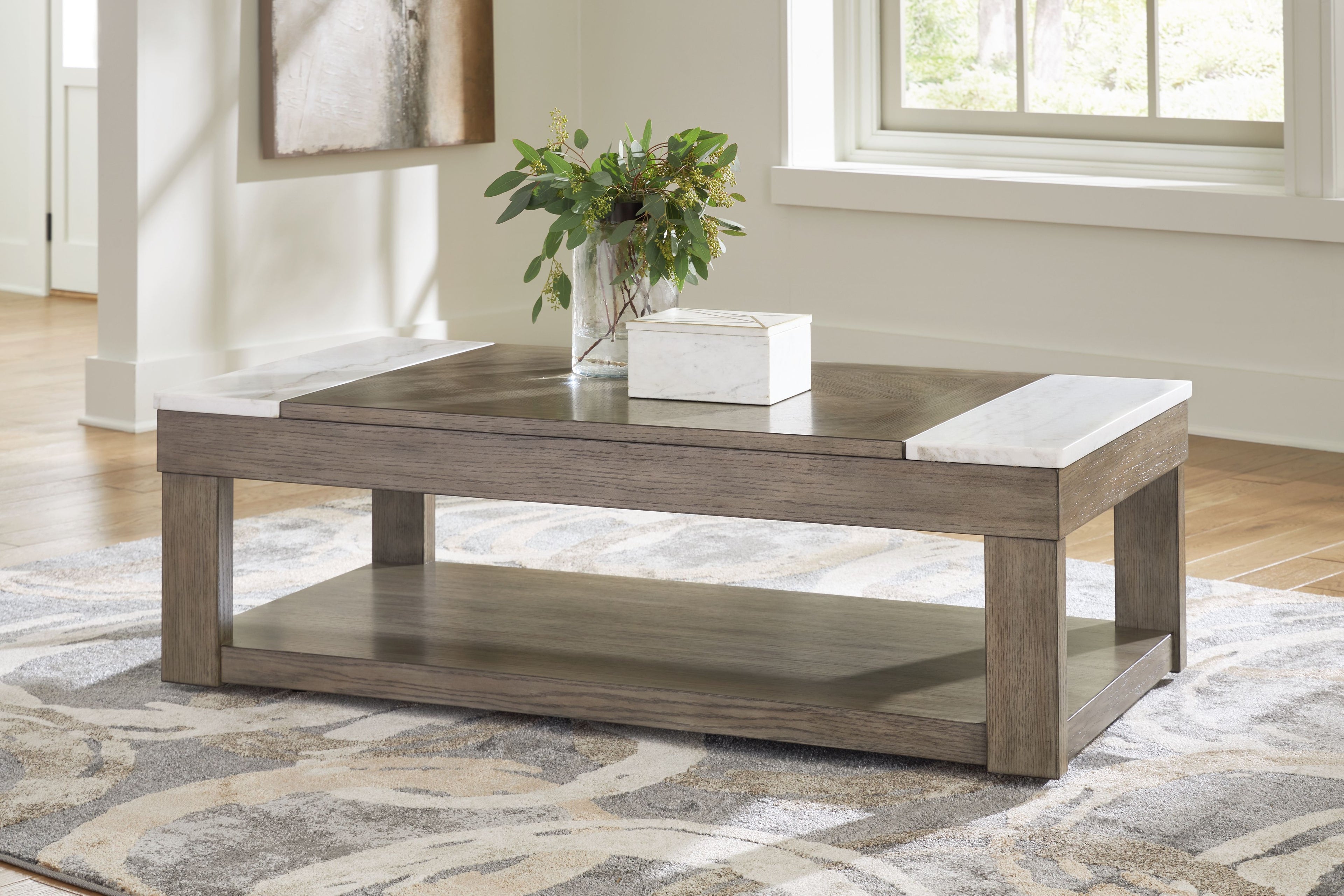 Grayish brown lift-top cocktail table with white side panels, styled with vase