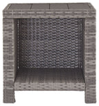Gray square end table with woven rattan front panel and dark tabletop, open interior