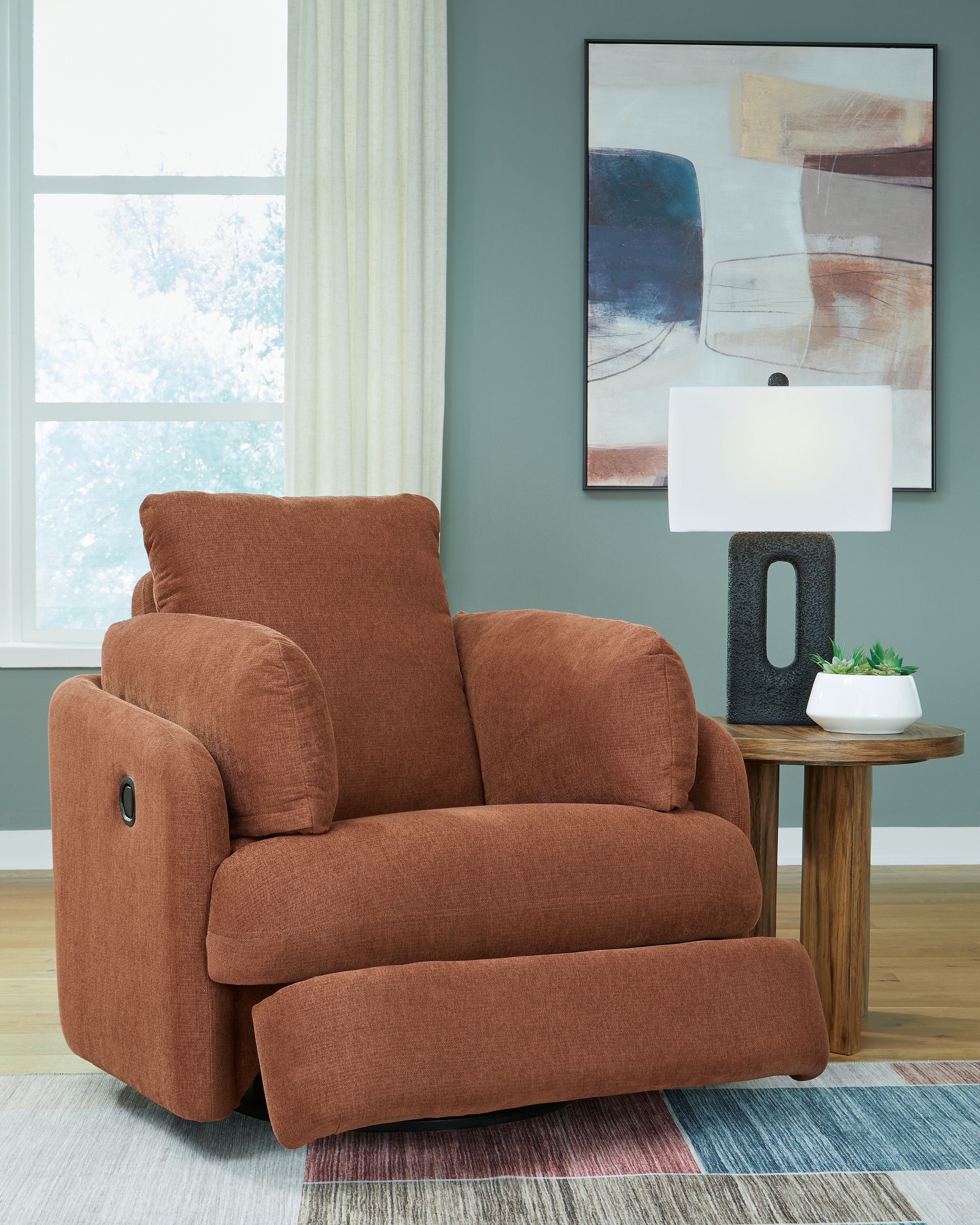 Swivel glider recliner chair in brown fabric, footrest extended for reclining.