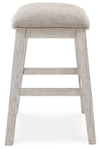 Upholstered vanity stool with rounded beige seat and light wood frame, lower rung