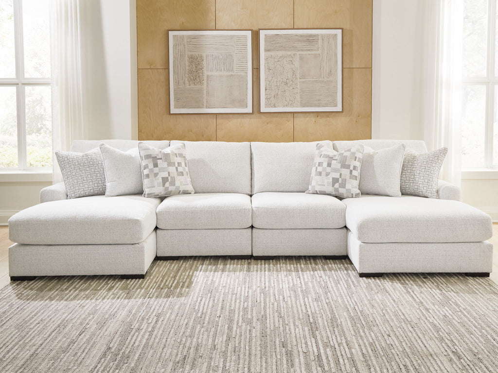 Off-white sectional sofa with chaise, clean-lined arms and square accent pillows