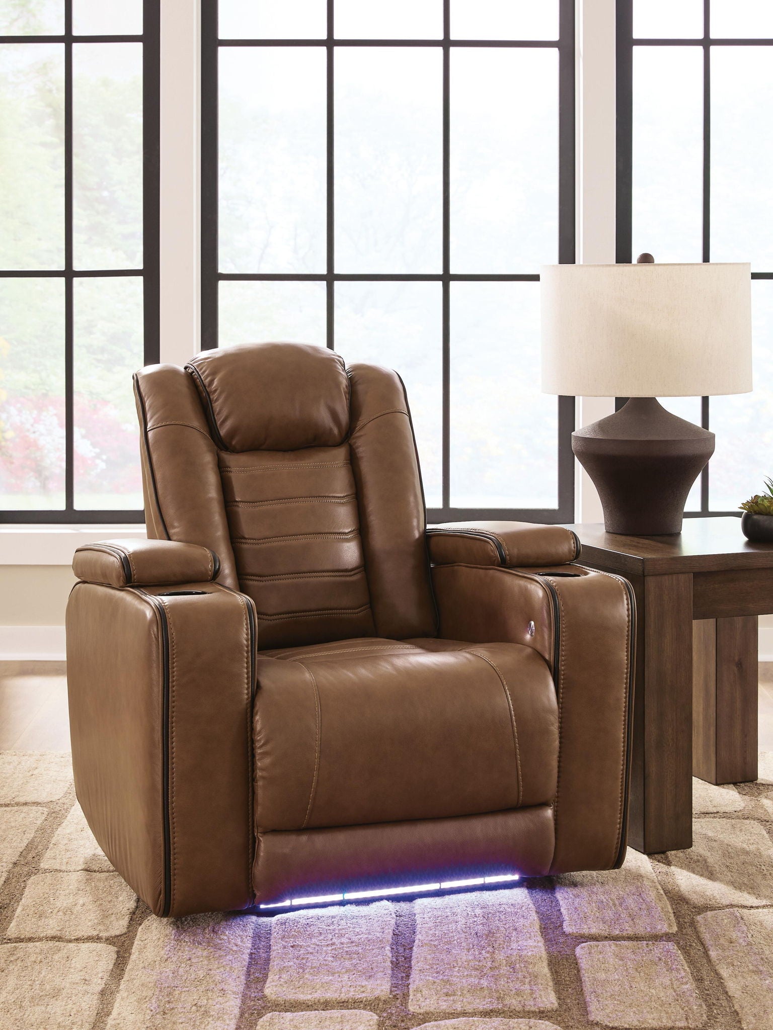 Brown recliner chair with adjustable headrest, padded arms, and cushioned seat