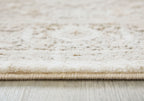Beige rug pile close-up with bound edge and subtle distressed texture