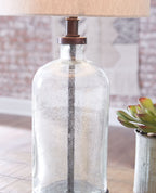 Clear glass table lamp body with bronze top cap and socket