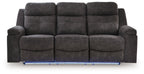 Charcoal reclining sofa with three seat pads and buttoned back cushions