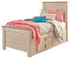 Beige panel bed with two front drawers and slatted headboard, styled with layered quilts