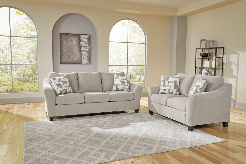 Taupe upholstered sofa and loveseat set with matching accent pillows