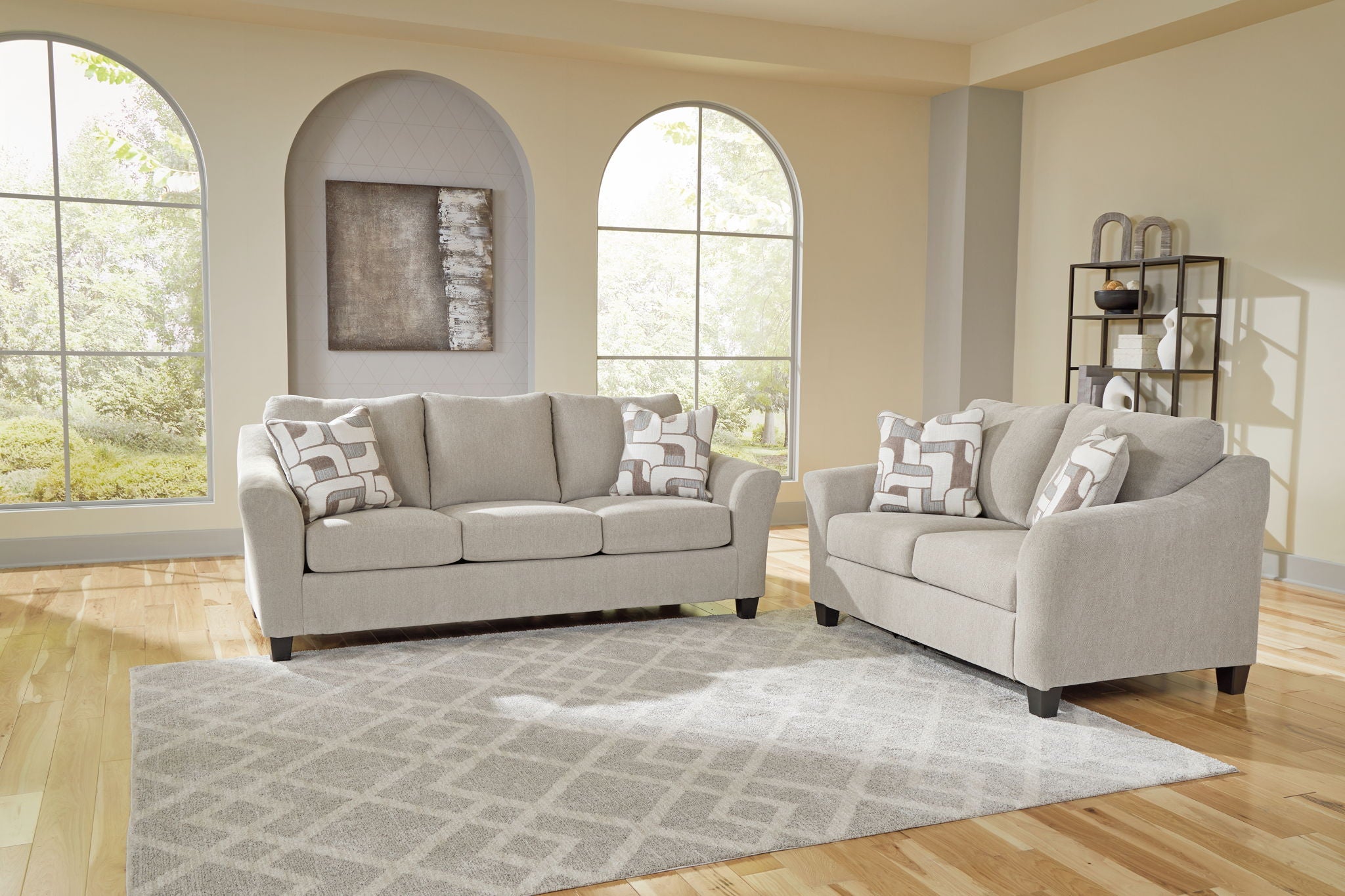 Taupe upholstered sofa and loveseat set with matching accent pillows