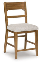 Upholstered barstool with light gray padded seat and light brown wood frame, arched backrest.