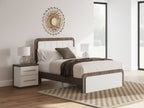 Upholstered bed with white bedding, dark wood frame, and panel headboard