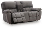 Dark gray power recline loveseat with built-in console and padded adjustable headrests